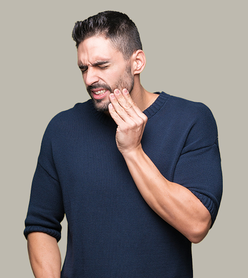Man with toothache touching jaw in discomfort.
