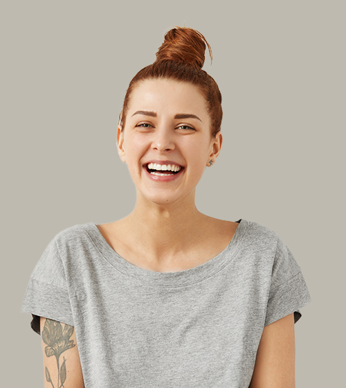 Happy woman with bun smiling, grey background.