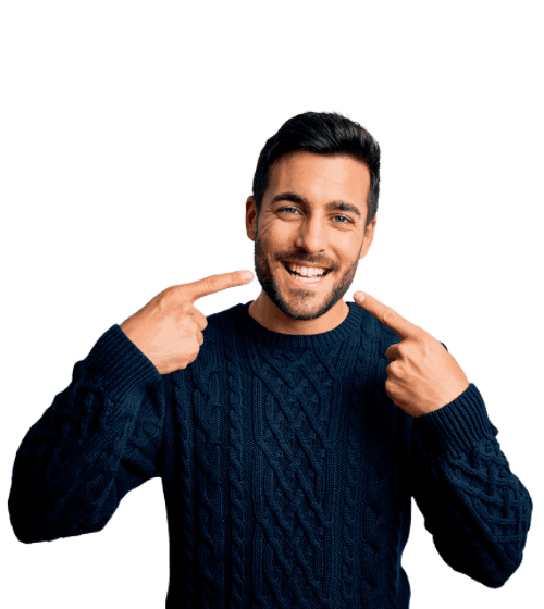 Man in navy sweater pointing at smile, grey background.