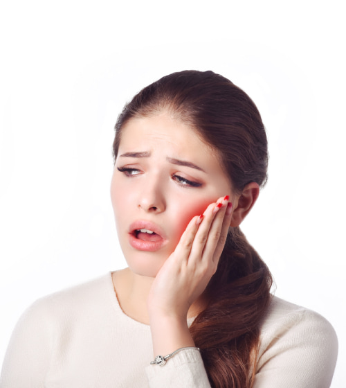 Woman holding cheek in pain, toothache expression.